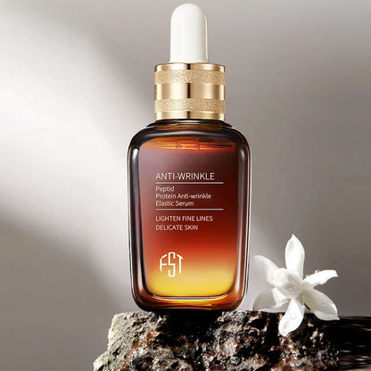 Anti-wrinkle serum bottle with dropper on a rock with a white flower, against a neutral background